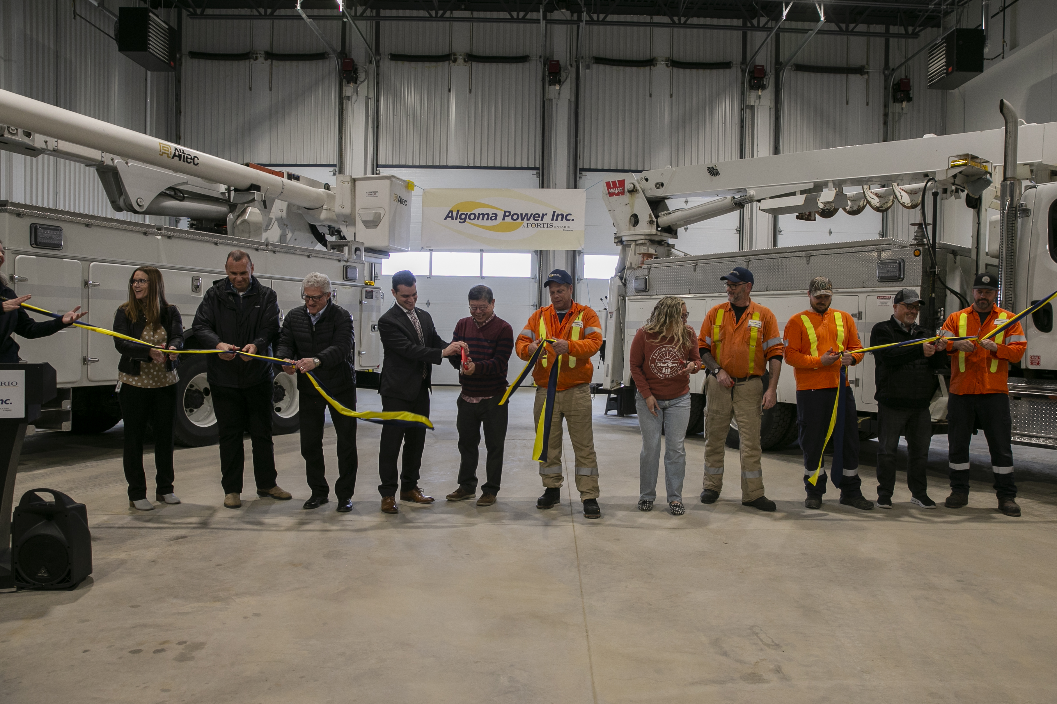 API Staff & Executive of FortisOntario, City of Sault Ste. Marie Mayor Shoemaker & Staff of the S.&T. Group and Tulloch Engineering cutting the ribbon.